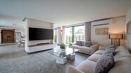 Enjoying movies on the 75 Inch smart-TV, sitting on the designer sofa