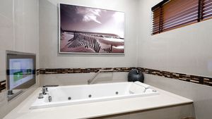 A Jacuzzi tub with TV program