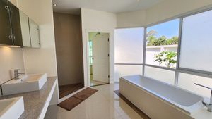 A bathtub and shower space - the master bathroom