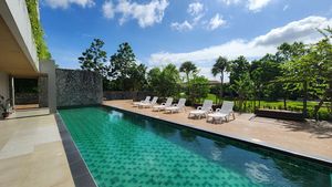 A large communal pool with deckchairs