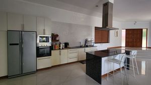 A large kitchen with a breakfast bar