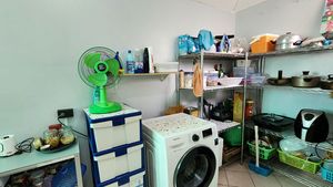 A large storage-room with the washing-machine