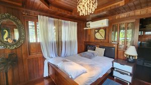 A traditional massive wooden bedroom in the guest villa