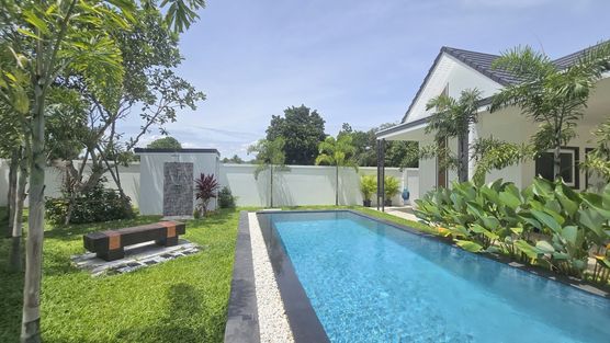 An overflow pool with Jacuzzi bench and a lovely garden