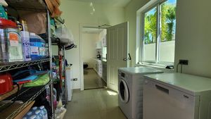 Between carport and kitchen - the pantry and laundry room