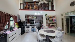 Dining-area with kitchen and gallrey in the background