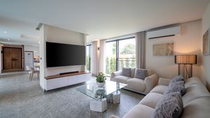 Enjoying movies on the 75 Inch smart-TV, sitting on the designer sofa