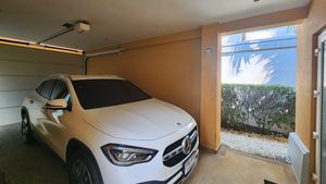 Garage with auto rolling gate