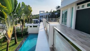 Large balconies are wrapped around the bedrooms