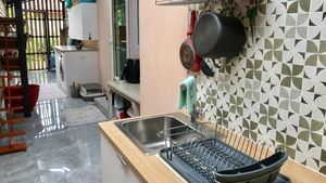 The Thai kitchen and washing machine plus dryer are at a covered area behind the house