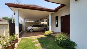 The carport, foregarden and entrance area