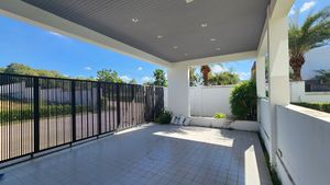 The carport hosts many vehicles