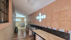 The covered Thai kitchen, washing machine and storage area