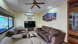 The cozy living-room with a 75 Inch-TV set