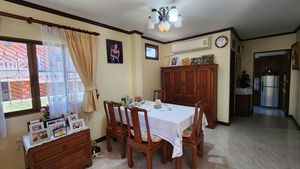 The dining-area with the kitchen room in the background