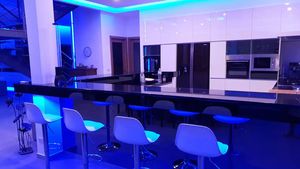 The kitchen and its bar with ambient lights