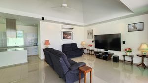 The living-room with the kitchen in the background