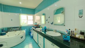 The spacious master-bathroom offers a Jacuzzi tub as well