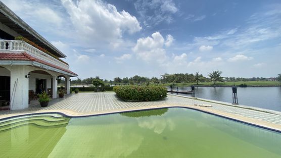 Views across the pool, the villa and the waterway