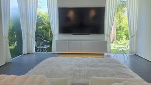 Views to tropical greenery or watch a movie - the master bedroom